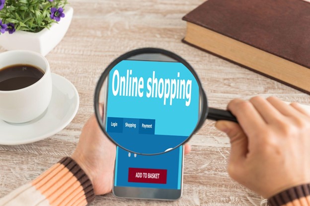 Magnifying glass zooms in on an online store with an add to cart button